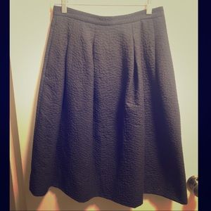 Black textured pleated midi skirt